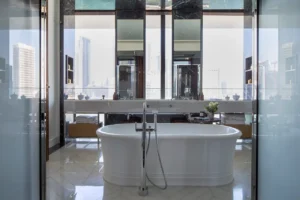 The Lana Residences Dorchester Collection by Omniyat 4 bedroom bathroom with freestanding bathtub marble finishes and skyline view in Dubai - Presented by Tohid Fetrat