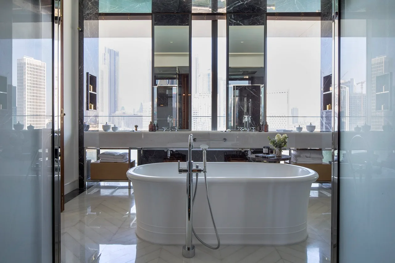 The Lana Residences Dorchester Collection by Omniyat 4 bedroom bathroom with freestanding bathtub marble finishes and skyline view in Dubai - Presented by Tohid Fetrat