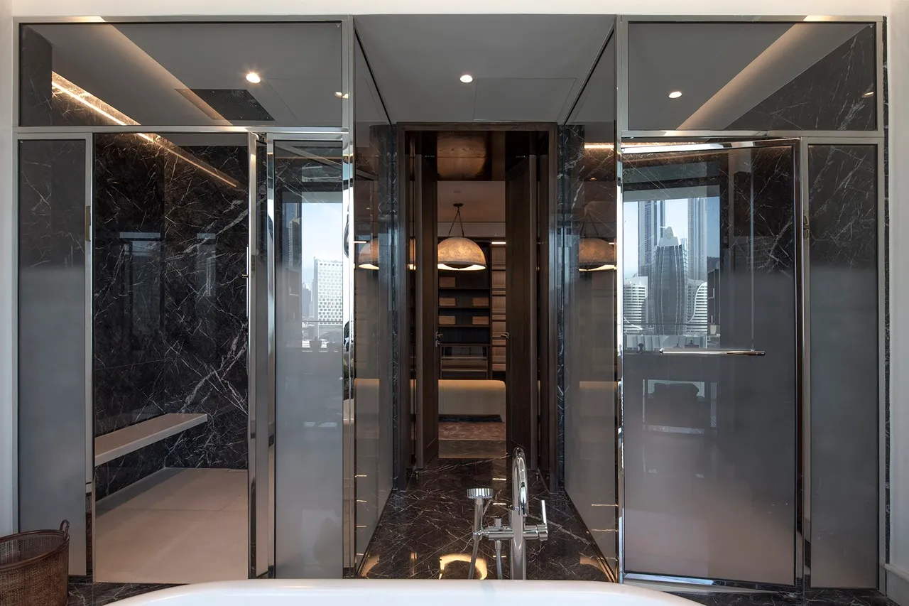 The Lana Residences Dorchester Collection by Omniyat 4 bedroom bathroom with marble shower glass partitions and luxury fittings in Dubai - Presented by Tohid Fetrat