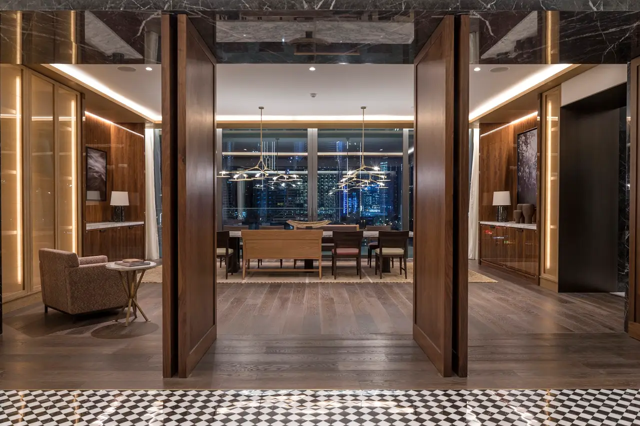 The Lana Residences Dorchester Collection by Omniyat 4 bedroom dining and living area with city night view and elegant lighting in Dubai - Presented by Tohid Fetrat