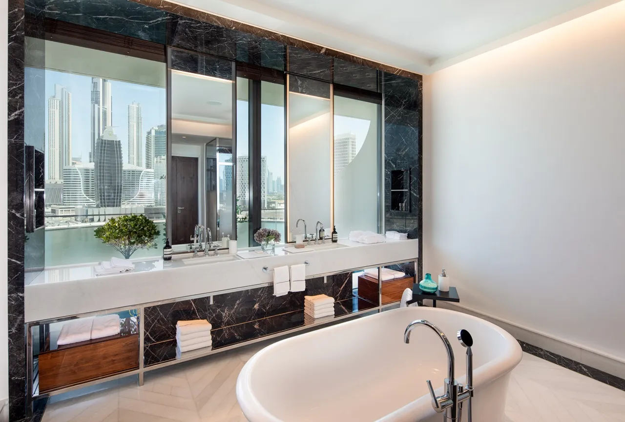 The Lana Residences Dorchester Collection by Omniyat 4 bedroom duplex bathroom with freestanding bathtub marble finishes and waterfront skyline view in Dubai - Presented by Tohid Fetrat