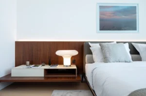 The Lana Residences Dorchester Collection by Omniyat 4 bedroom duplex bedroom detail with bedside table soft lighting and wood panel headboard in Dubai - Presented by Tohid Fetrat