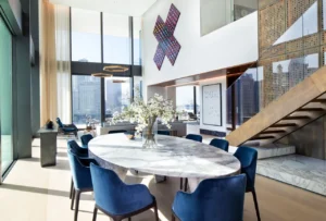 The Lana Residences Dorchester Collection by Omniyat 4 bedroom duplex double height living and dining area with marble table staircase and city views in Dubai - Presented by Tohid Fetrat