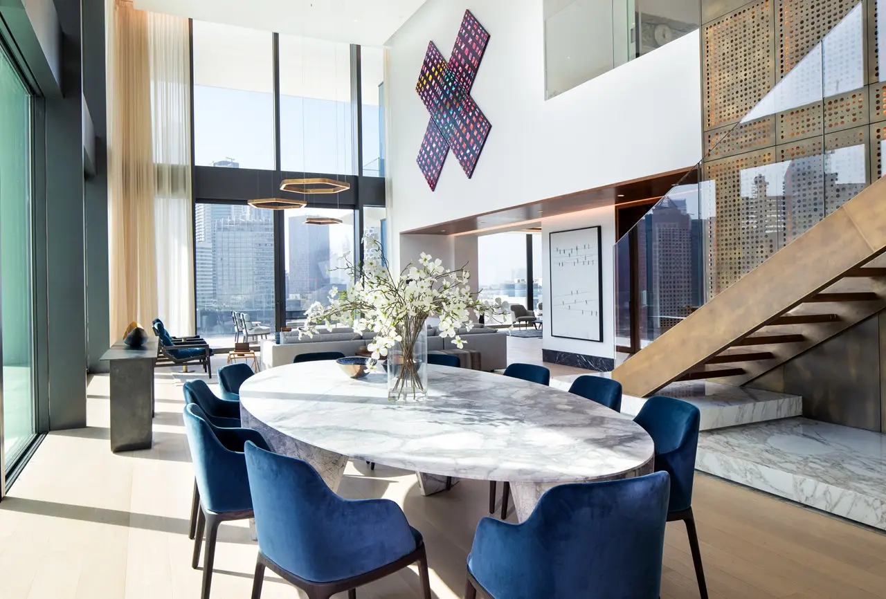 The Lana Residences Dorchester Collection by Omniyat 4 bedroom duplex double height living and dining area with marble table staircase and city views in Dubai - Presented by Tohid Fetrat