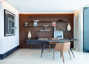 The Lana Residences Dorchester Collection by Omniyat 4 bedroom duplex home office with wood feature wall shelving and modern desk layout in Dubai - Presented by Tohid Fetrat