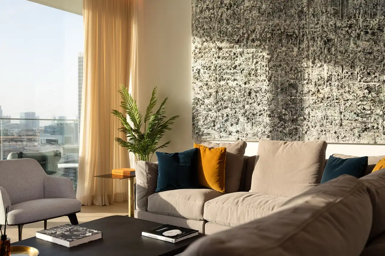 The Lana Residences Dorchester Collection by Omniyat 4 bedroom duplex living area with textured wall art and natural light in Dubai - Presented by Tohid Fetrat