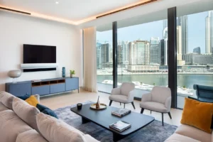 The Lana Residences Dorchester Collection by Omniyat 4 bedroom duplex living room with waterfront skyline view floor to ceiling windows and modern interior in Dubai - Presented by Tohid Fetrat