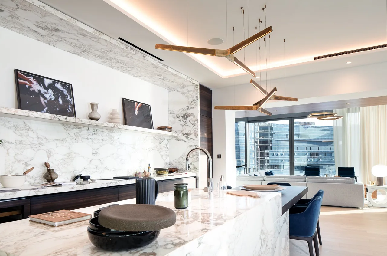 The Lana Residences Dorchester Collection by Omniyat 4 bedroom duplex marble kitchen island with open plan living area and large windows in Dubai - Presented by Tohid Fetrat