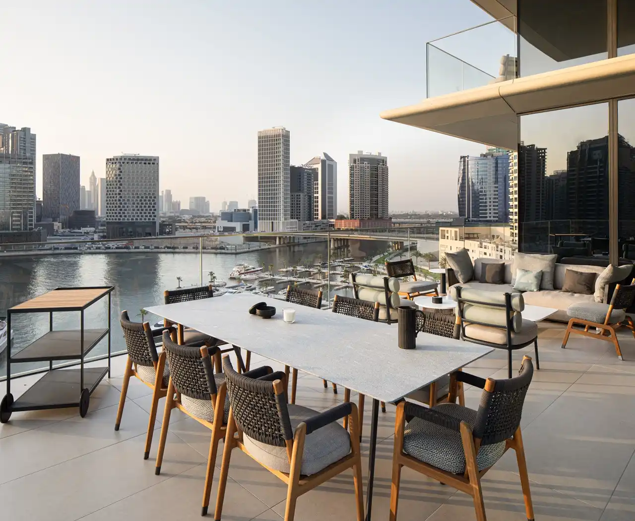 The Lana Residences Dorchester Collection by Omniyat 4 bedroom duplex terrace with marina view outdoor dining and luxury seating in Dubai - Presented by Tohid Fetrat