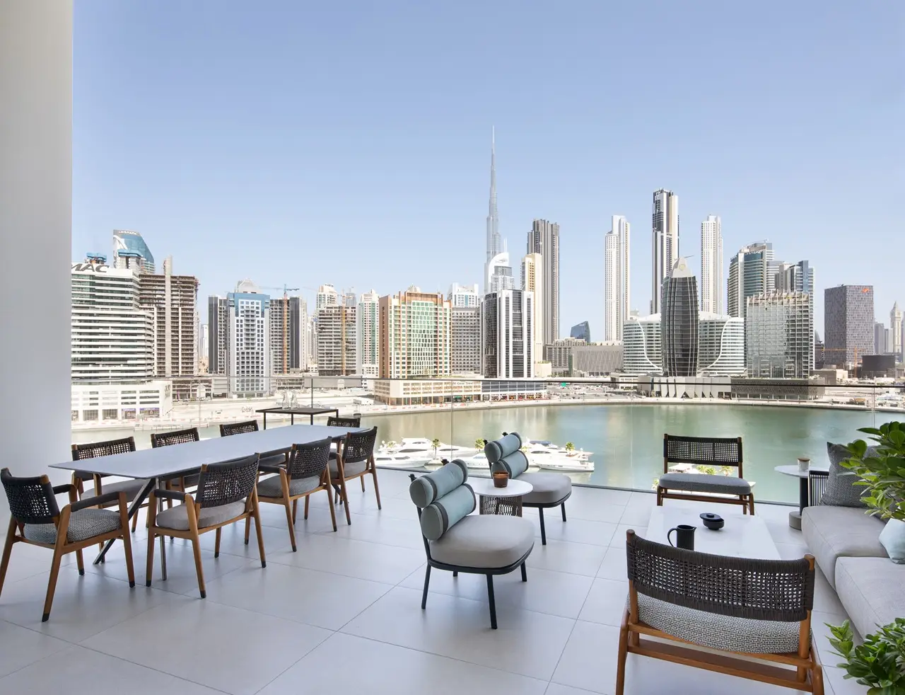 The Lana Residences Dorchester Collection by Omniyat 4 bedroom duplex terrace with Burj Khalifa view waterfront skyline and outdoor seating in Dubai - Presented by Tohid Fetrat