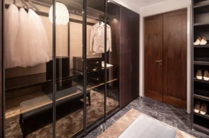 The Lana Residences Dorchester Collection by Omniyat 4 bedroom duplex walk in closet with glass wardrobes custom storage and luxury interior design in Dubai - Presented by Tohid Fetrat