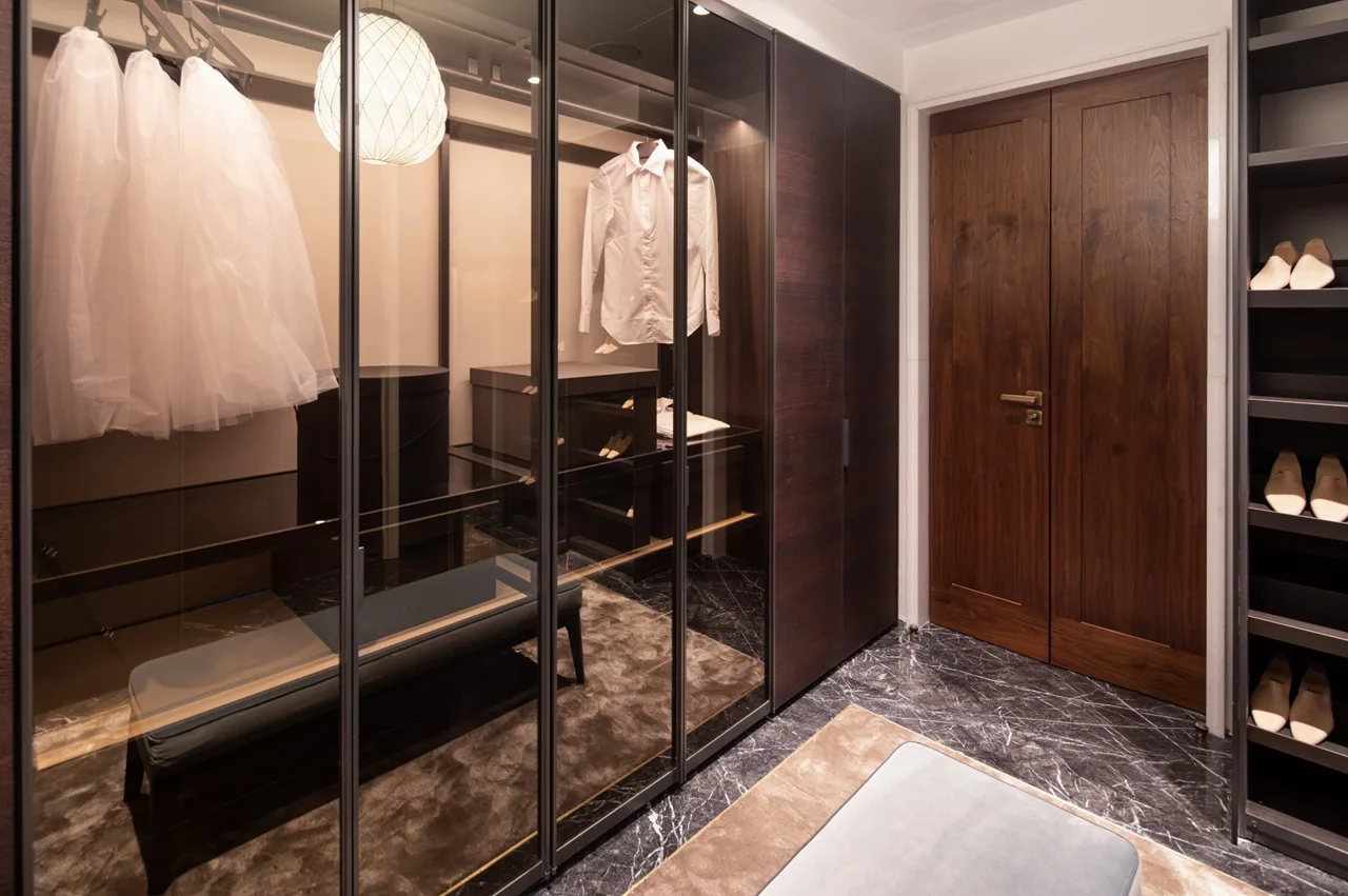 The Lana Residences Dorchester Collection by Omniyat 4 bedroom duplex walk in closet with glass wardrobes custom storage and luxury interior design in Dubai - Presented by Tohid Fetrat