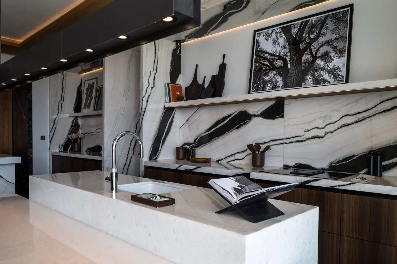 The Lana Residences Dorchester Collection by Omniyat 4 bedroom kitchen detail with marble island sink and bold stone backsplash in Dubai - Presented by Tohid Fetrat