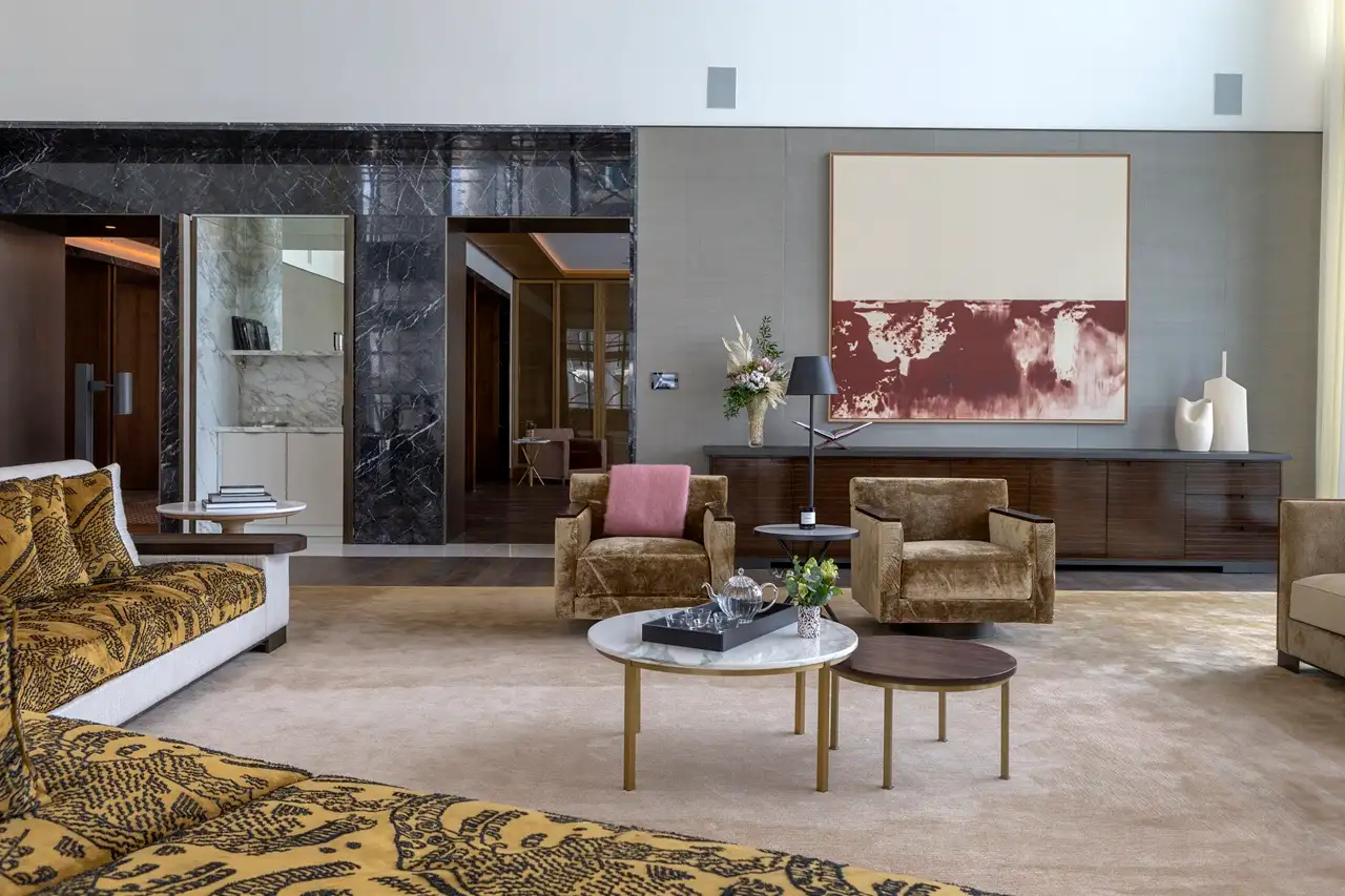 The Lana Residences Dorchester Collection by Omniyat 4 bedroom luxury living room with lounge seating marble tables and refined interior styling in Dubai - Presented by Tohid Fetrat