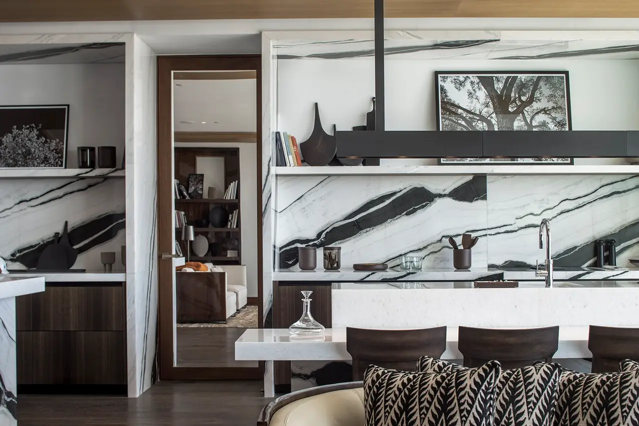 The Lana Residences Dorchester Collection by Omniyat 4 bedroom kitchen with bold marble wall feature and modern island seating in Dubai - Presented by Tohid Fetrat