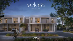 Velora The Valley by Emaar townhouse evening front exterior with illuminated interiors and covered parking in Dubai - Presented by Tohid Fetrat