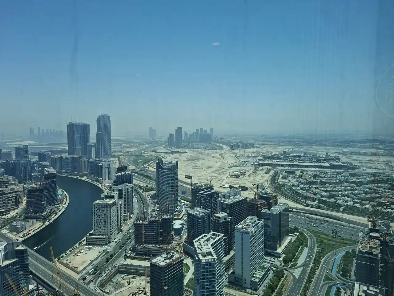 Business Bay skyline and Dubai Canal development showing why construction updates matter for Dubai property investors Presented by Tohid Fetrat