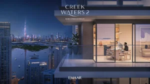 Creek Waters 2 at Dubai Creek Harbour by Emaar apartment balcony with night city skyline and illuminated interior dining area in Dubai - Presented by Tohid Fetrat
