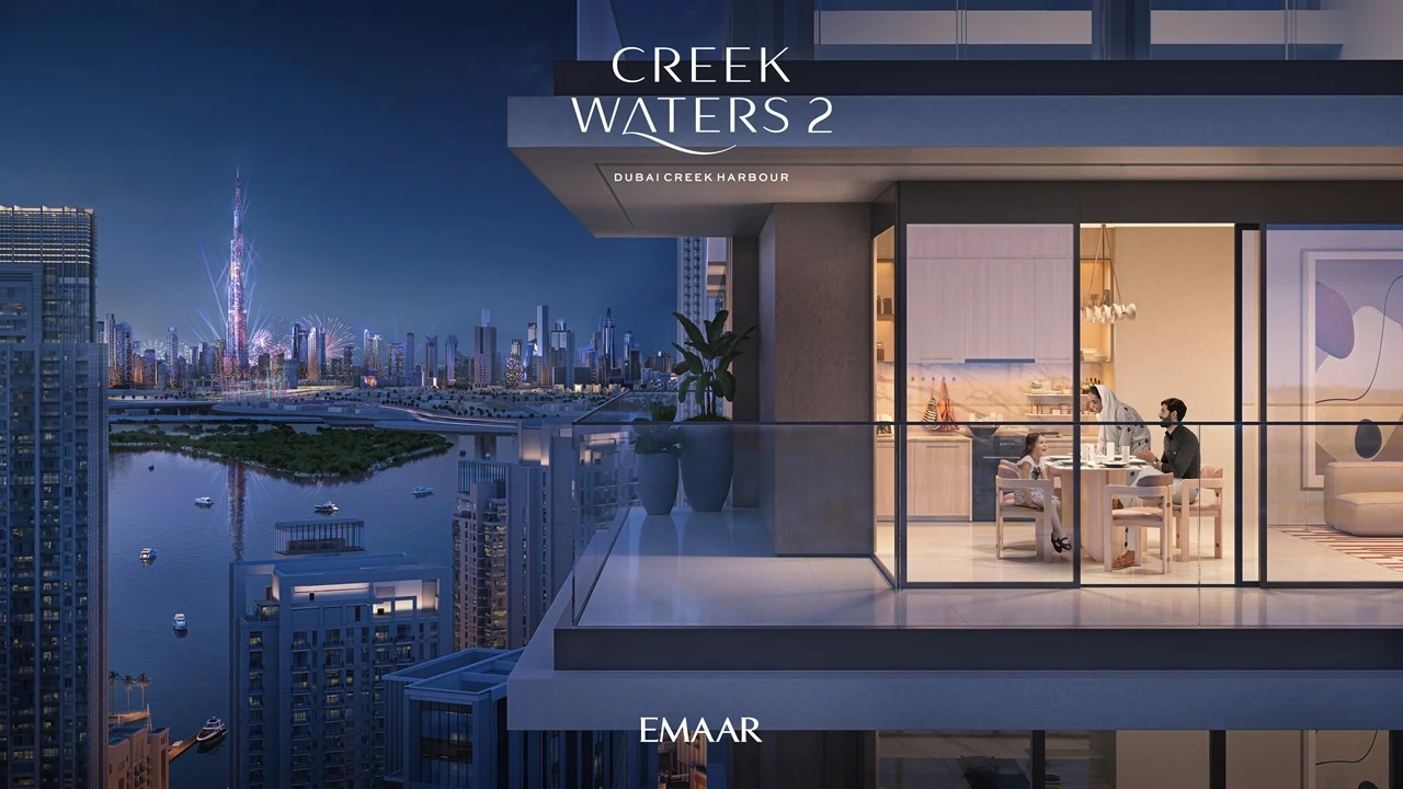 Creek Waters 2 at Dubai Creek Harbour by Emaar apartment balcony with night city skyline and illuminated interior dining area in Dubai - Presented by Tohid Fetrat