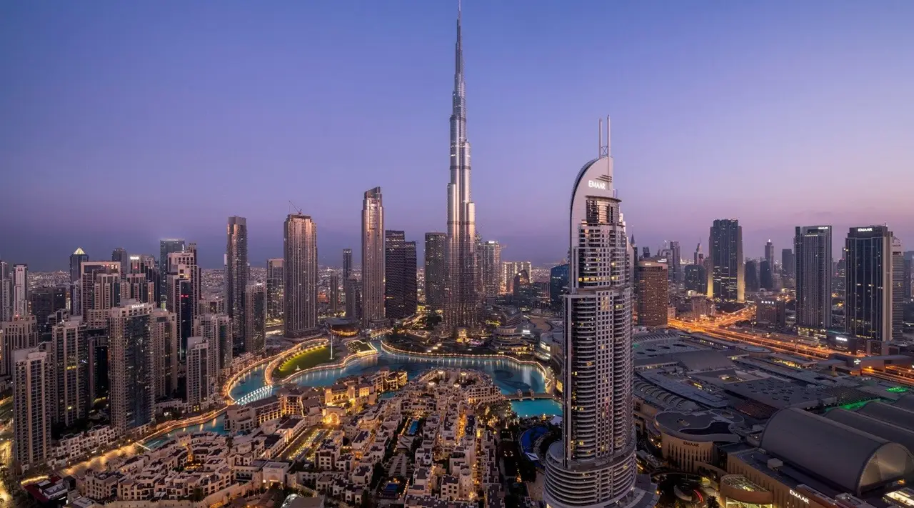 Emaar Properties developer showcasing Downtown Dubai skyline with Burj Khalifa and surrounding residential and commercial towers at dusk Presented by Tohid Fetrat