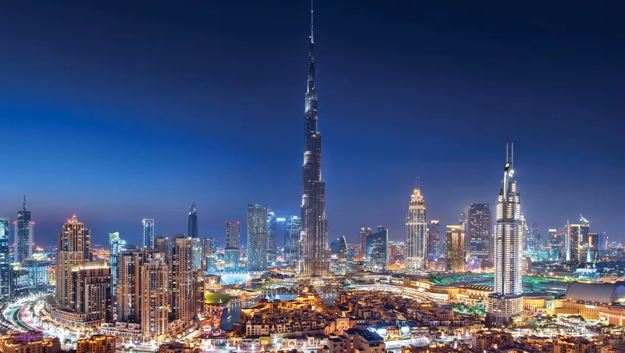 Emaar Properties for Sale in Dubai featuring Downtown skyline with Burj Khalifa illuminated at night Presented by Tohid Fetrat