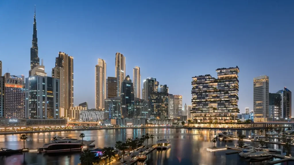 ENARA by OMNIYAT construction updates featuring luxury waterfront residences and Dubai skyline at night Presented by Tohid Fetrat
