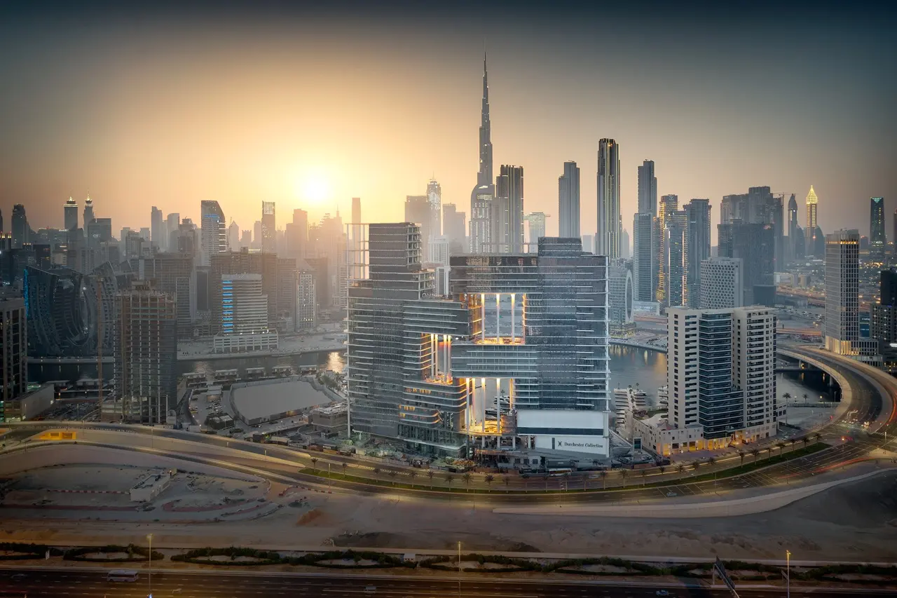 Omniyat Properties for Sale in Dubai featuring luxury mixed use development with modern architecture and Downtown skyline at sunset Presented by Tohid Fetrat