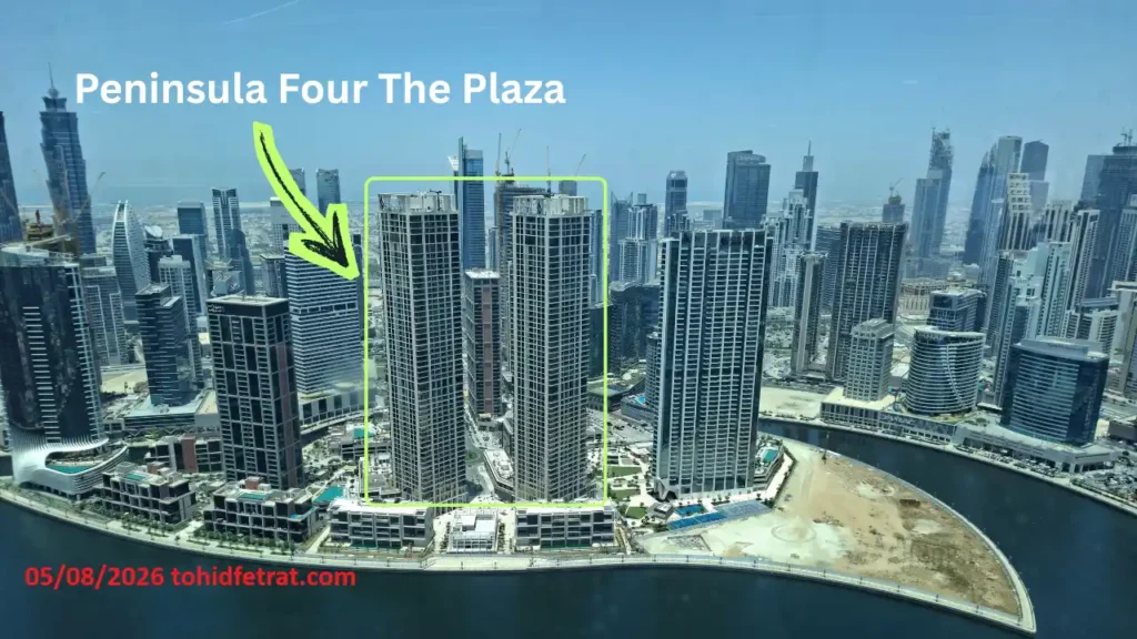 Peninsula Four The Plaza construction update April 2026 showing twin residential towers beside Dubai Water Canal captured by Tohid Fetrat