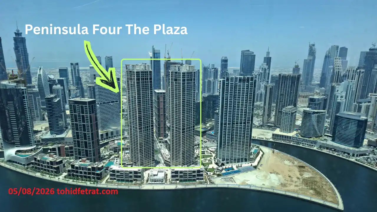 Peninsula Four The Plaza construction update April 2026 showing twin residential towers beside Dubai Water Canal captured by Tohid Fetrat