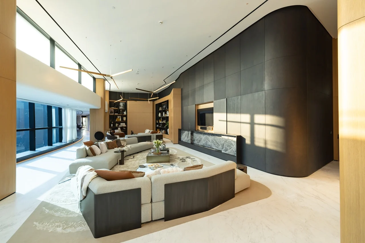 The Opus Penthouse by OMNIYAT double height living area with panoramic windows, luxury furnishings, and contemporary interior architecture in Dubai - Presented by Tohid Fetrat