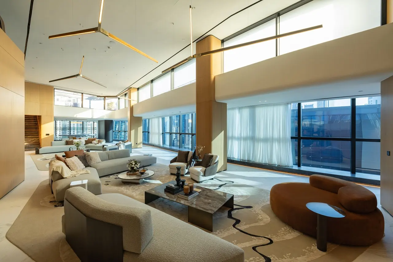 The Opus Penthouse by OMNIYAT double height lounge space with floor to ceiling windows, designer seating, and luxury contemporary interiors in Dubai - Presented by Tohid Fetrat