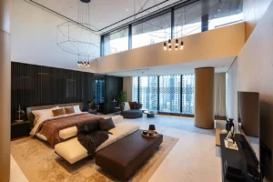 The Opus Penthouse by OMNIYAT master bedroom suite with double height ceilings, panoramic skyline views, and luxury contemporary interiors in Dubai - Presented by Tohid Fetrat