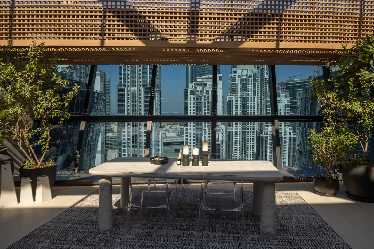 The Opus Penthouse by OMNIYAT outdoor lounge with skyline views, landscaped greenery, and luxury contemporary design in Dubai - Presented by Tohid Fetrat