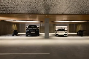 The Opus Penthouse by OMNIYAT private luxury car gallery with premium lighting and modern architectural finishes in Dubai - Presented by Tohid Fetrat