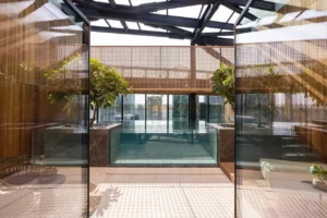 The Opus Penthouse by OMNIYAT private indoor pool with skylight ceiling, landscaped surroundings, and contemporary luxury architecture in Dubai - Presented by Tohid Fetrat