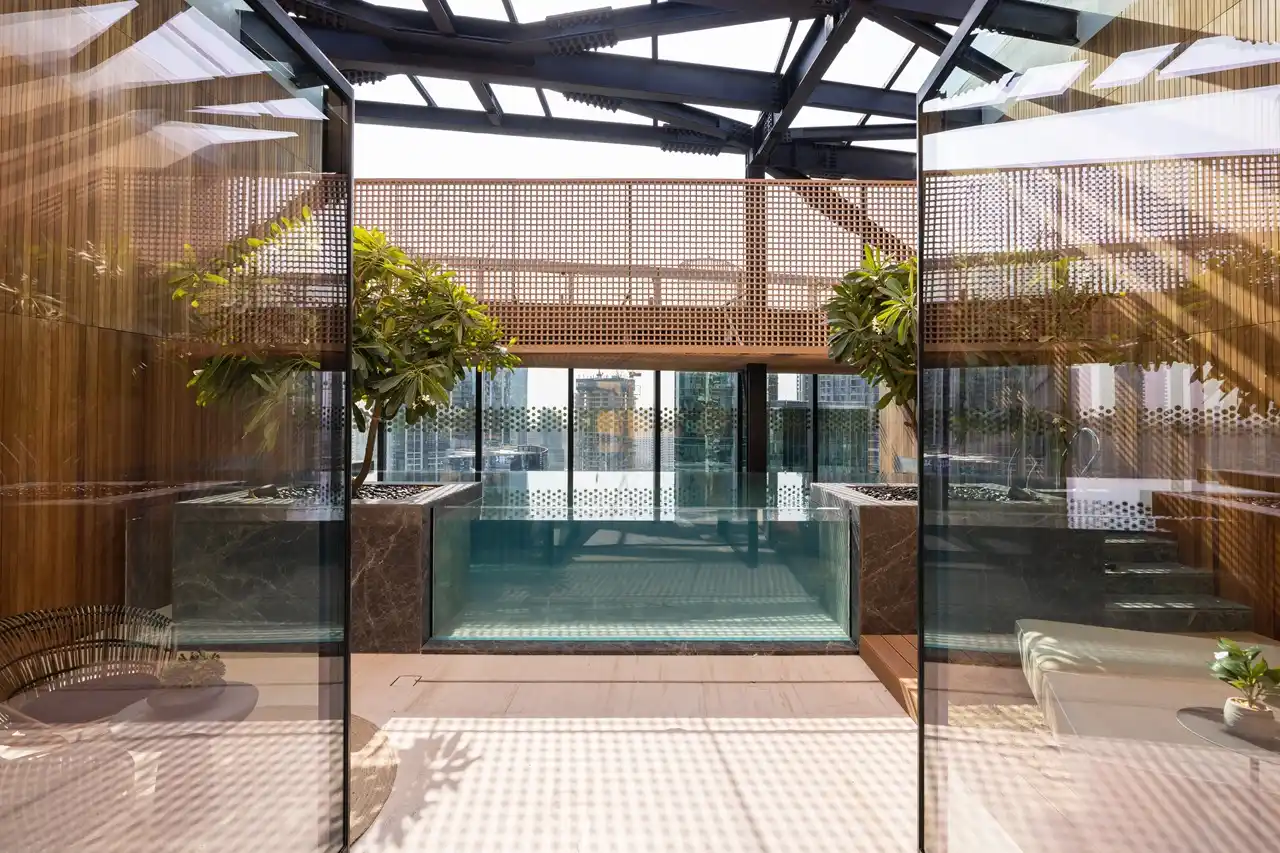The Opus Penthouse by OMNIYAT private indoor pool with skylight ceiling, landscaped surroundings, and contemporary luxury architecture in Dubai - Presented by Tohid Fetrat