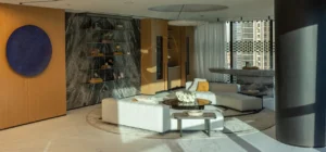 The Opus Penthouse by OMNIYAT private lounge interior with marble finishes, designer furnishings, and contemporary luxury styling in Dubai - Presented by Tohid Fetrat