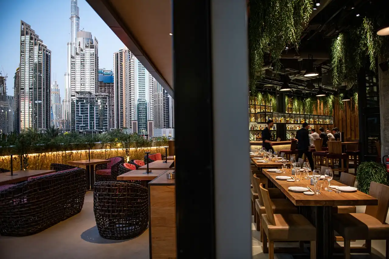 The Opus Residences by OMNIYAT Roka restaurant dining area with Dubai skyline views - Presented by Tohid Fetrat