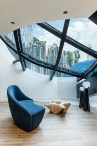 Architectural sky lounge with panoramic glass facade at The Opus Residences by OMNIYAT in Dubai - Presented by Tohid Fetrat