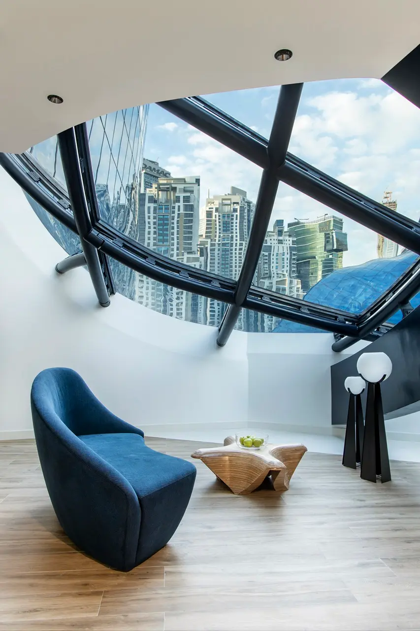Architectural sky lounge with panoramic glass facade at The Opus Residences by OMNIYAT in Dubai - Presented by Tohid Fetrat