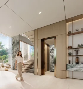 Tilal Binghatti Grand Mansion by Binghatti luxury elevator lobby with marble finishes and floating staircase in Dubai - Presented by Tohid Fetrat