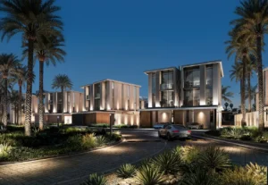 Tilal Binghatti Mansion nighttime exterior with illuminated modern architecture, landscaped streets, and luxury residential surroundings in Dubai - Presented by Tohid Fetrat