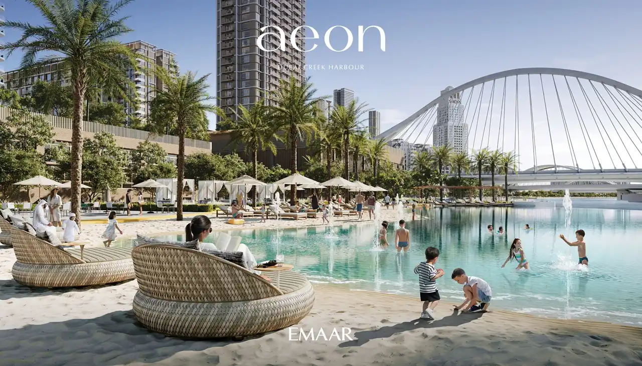 AEON at Dubai Creek Harbour by Emaar Properties residential towers with beach lagoon, palm trees, sun loungers, bridge views and family leisure spaces in Dubai Presented by Tohid Fetrat