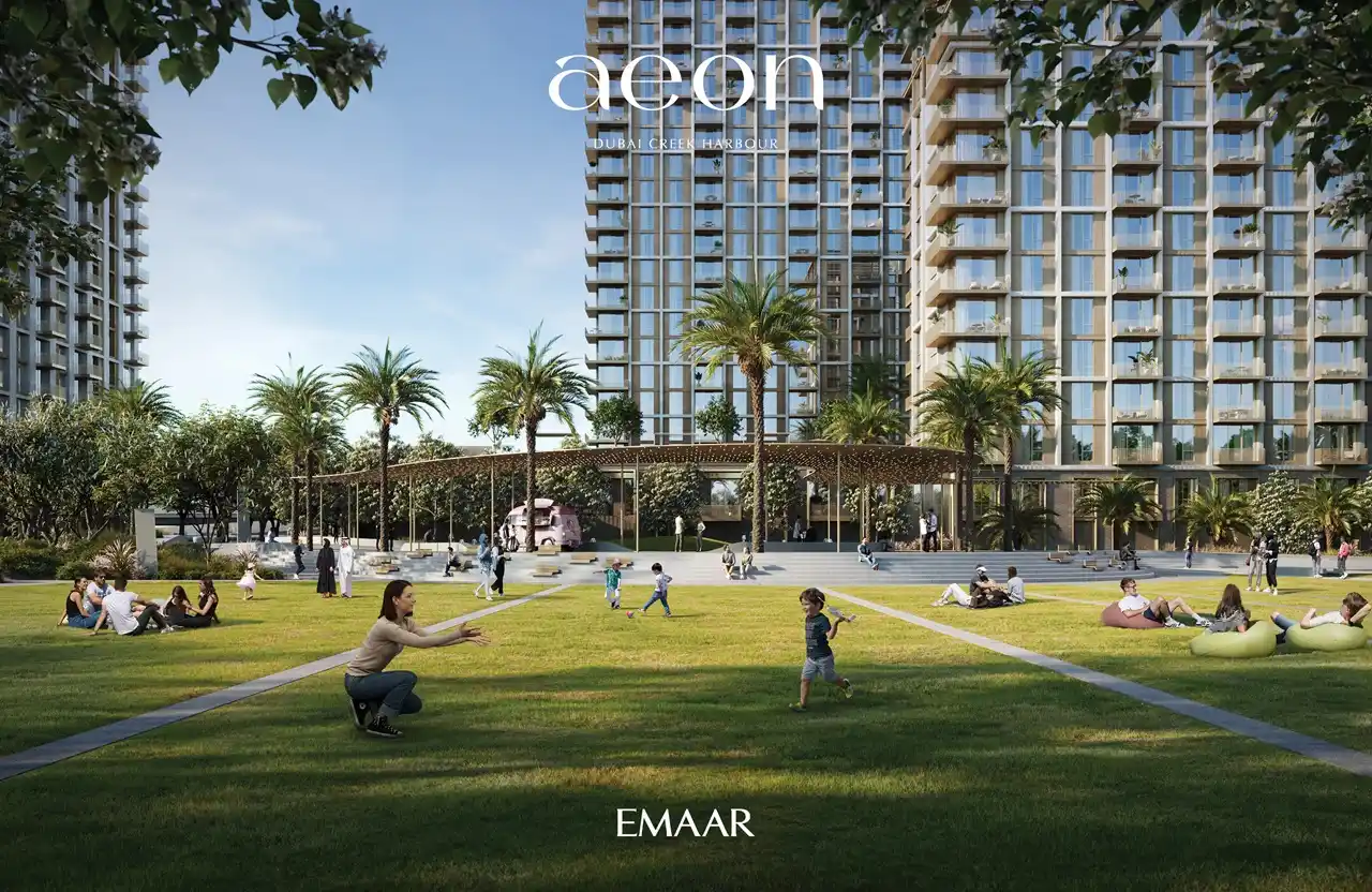 AEON at Dubai Creek Harbour by Emaar Properties residential towers with landscaped lawn, palm trees, shaded seating and outdoor family spaces in Dubai Presented by Tohid Fetrat