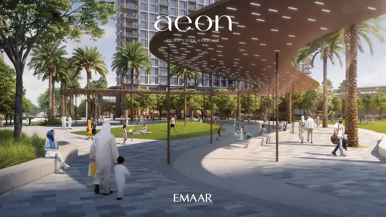 AEON at Dubai Creek Harbour by Emaar Properties residential towers with shaded leisure plaza, palm trees, landscaped lawn and outdoor seating in Dubai Presented by Tohid Fetrat