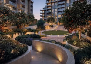 Arancia at The Yards by Beyond Developments landscaped garden courtyard with illuminated pathways and residential buildings in Dubai Presented by Tohid Fetrat