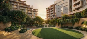 Arancia at The Yards by Beyond Developments sunken courtyard during golden hour with landscaped gardens and residential buildings in Dubai - Presented by Tohid Fetrat
