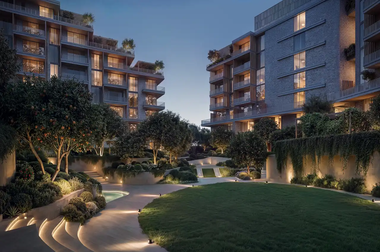 Arancia at The Yards by Beyond Developments sunken courtyard at night with illuminated landscaping and residential buildings in Dubai - Presented by Tohid Fetrat