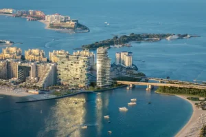 AVA at Palm Jumeirah, Dorchester Collection by OMNIYAT aerial waterfront location overlooking Palm Jumeirah shoreline and luxury residences in Dubai Presented by Tohid Fetrat