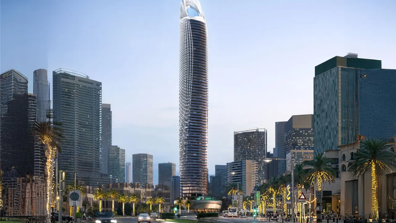 Binghatti Skyblade by Binghatti iconic residential tower rising above a palm lined boulevard with illuminated facade and modern skyline surroundings in Dubai - Presented by Tohid Fetrat
